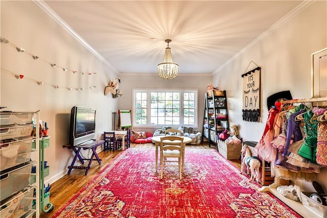 living room featuring hardwood / wood-style flooring, ornamental molding, and a chandelier