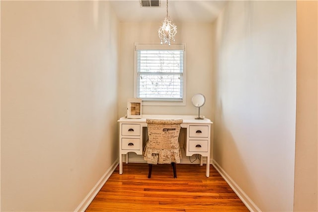 home office with light hardwood / wood-style floors