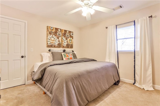 bedroom with ceiling fan and light carpet