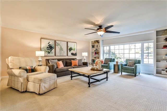 living room featuring ceiling fan, ornamental molding, carpet flooring, and built in features