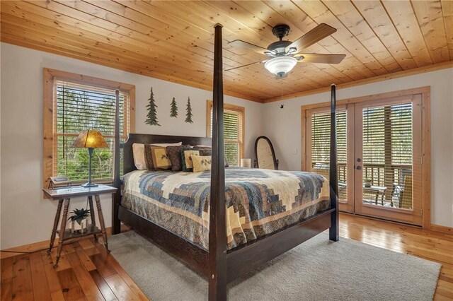 bedroom with wood ceiling, access to outside, wood-type flooring, crown molding, and ceiling fan