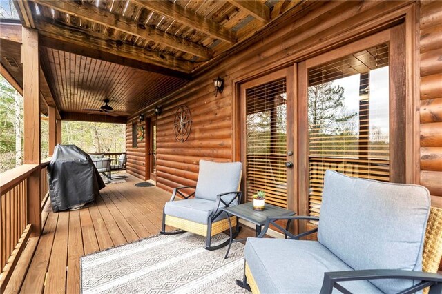 wooden terrace featuring a grill and ceiling fan