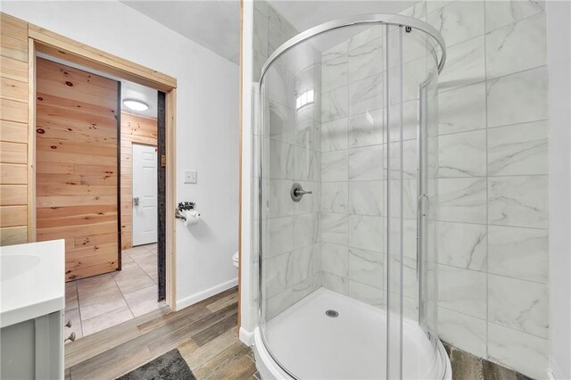 bathroom with vanity, hardwood / wood-style floors, walk in shower, and toilet