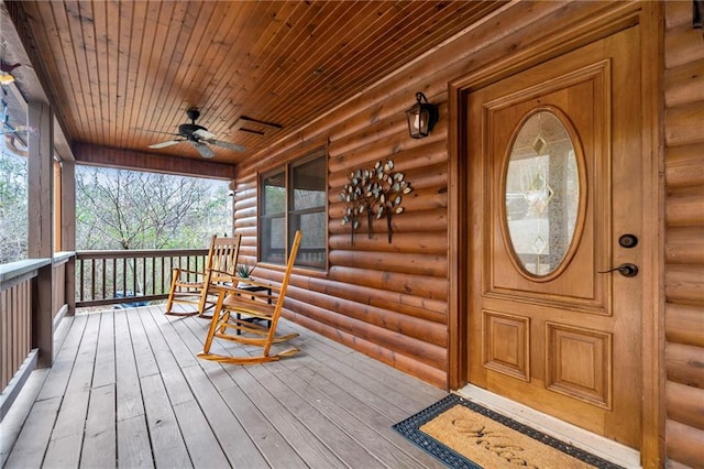 wooden terrace with covered porch and ceiling fan