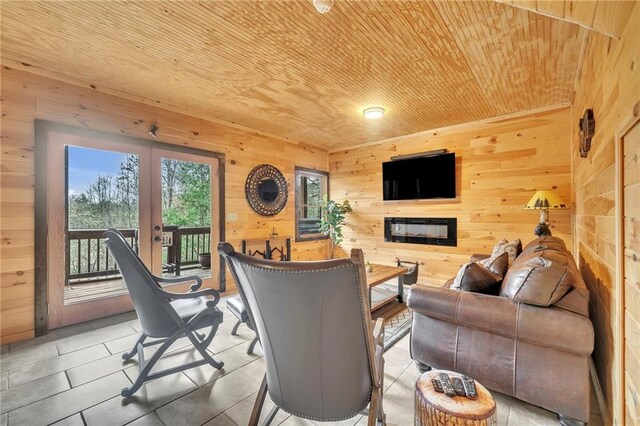 living room with french doors, wooden ceiling, and wood walls