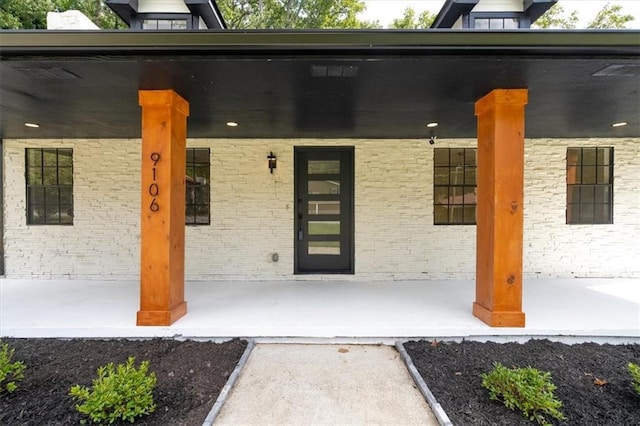 view of exterior entry featuring a porch