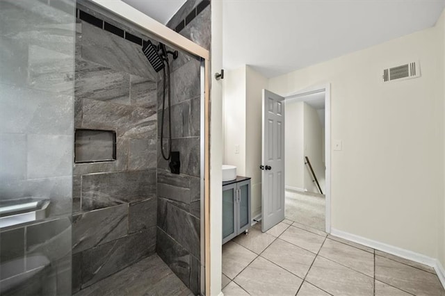 full bathroom with vanity, a shower stall, visible vents, and baseboards