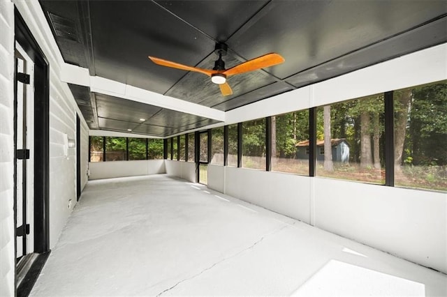 unfurnished sunroom with a ceiling fan