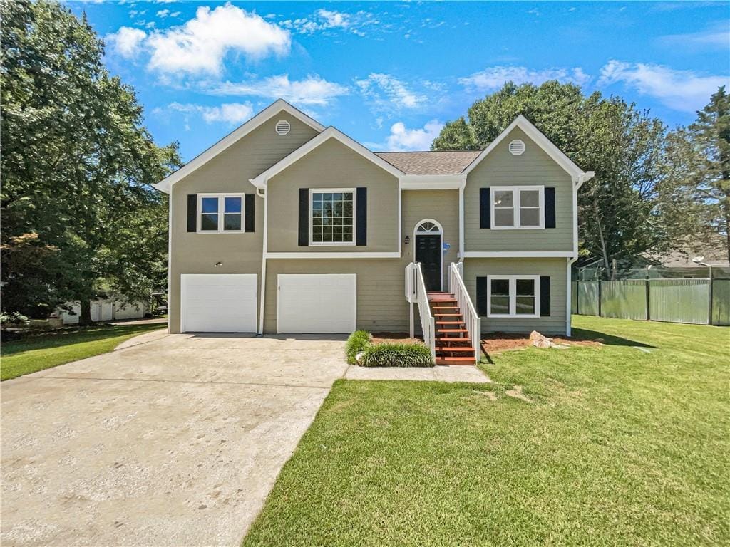 bi-level home with a front yard and a garage