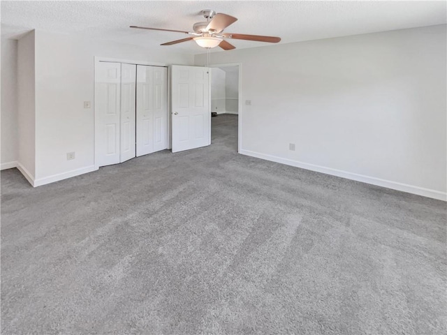 unfurnished bedroom featuring a closet, a textured ceiling, ceiling fan, and carpet