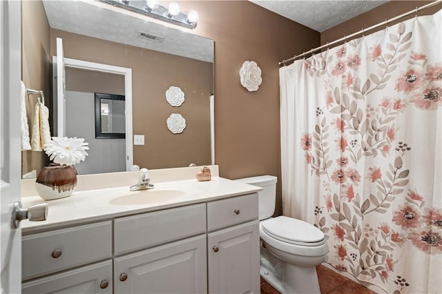 full bathroom with a textured ceiling, toilet, visible vents, vanity, and tile patterned floors