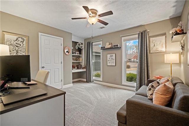 office space featuring visible vents, ceiling fan, a textured ceiling, and carpet flooring