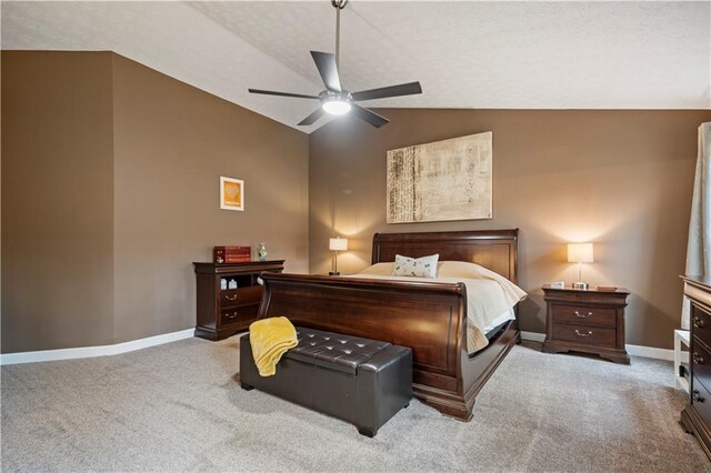 carpeted bedroom with lofted ceiling, ceiling fan, and baseboards