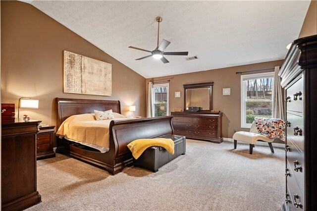 bedroom with light carpet, ceiling fan, visible vents, and vaulted ceiling