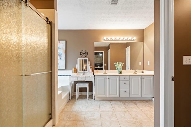 bathroom featuring visible vents, a garden tub, tile patterned flooring, a textured ceiling, and a shower stall