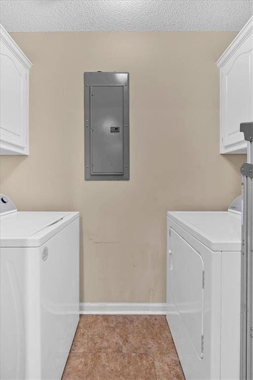 washroom with electric panel, separate washer and dryer, cabinets, and a textured ceiling