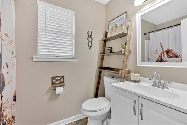 bathroom featuring vanity and toilet