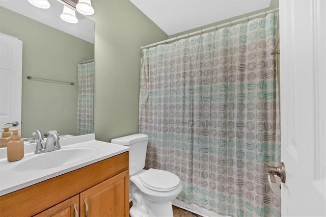 bathroom featuring a shower with curtain, vanity, and toilet