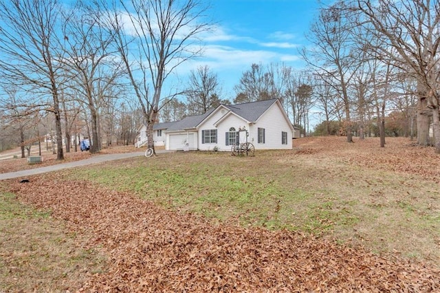 single story home featuring a front lawn and a garage