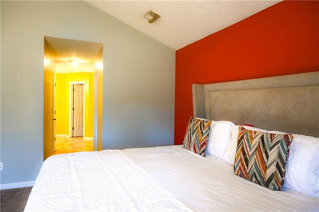 bedroom with lofted ceiling