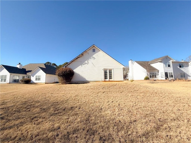 back of house with a yard and french doors