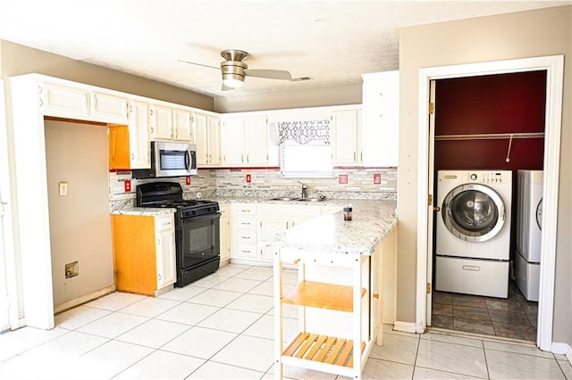 kitchen with white cabinetry, black gas stove, sink, and tasteful backsplash