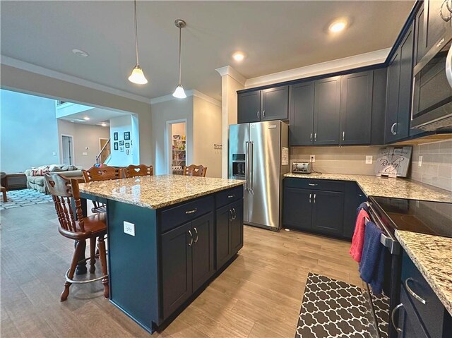 360 Walker Rd, Byron, GA 31008 - kitchen featuring stainless steel appliances, ornamental molding, a breakfast bar area, light stone counters, and light wood finished floors
