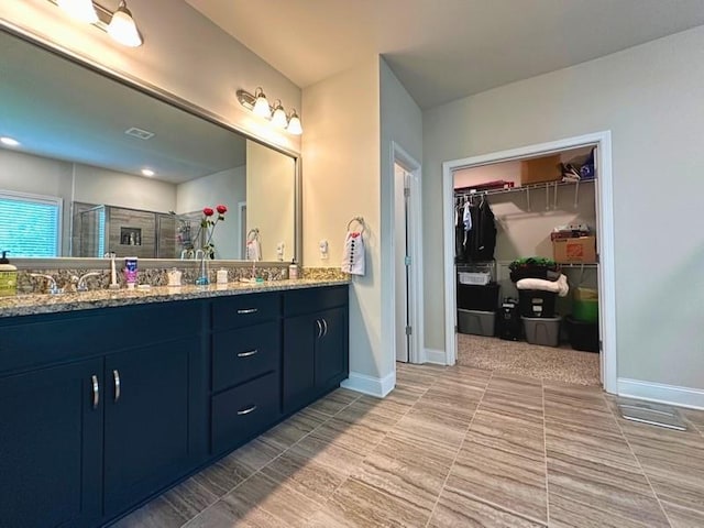 360 Walker Rd, Byron, GA 31008 - bathroom featuring double vanity, a stall shower, a walk in closet, and tile patterned flooring