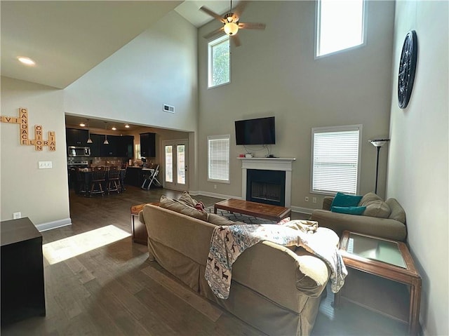 360 Walker Rd, Byron, GA 31008 - living room featuring ceiling fan, a towering ceiling, a fireplace, and dark wood-style floors