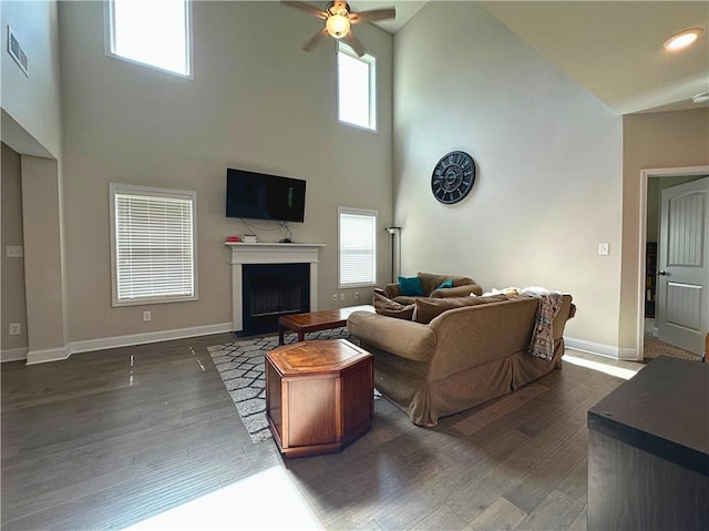 360 Walker Rd, Byron, GA 31008 - living area with high vaulted ceiling, ceiling fan, dark wood-style floors, and a fireplace with flush hearth