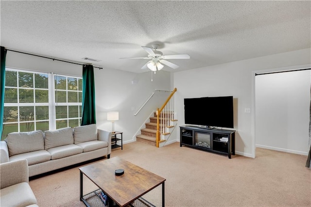 33 Middlebrook Dr, Cartersville, GA 30120 - living area with stairs, ceiling fan, light carpet, a textured ceiling, and baseboards