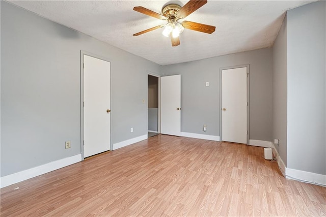 unfurnished bedroom with light hardwood / wood-style floors, ceiling fan, and a textured ceiling