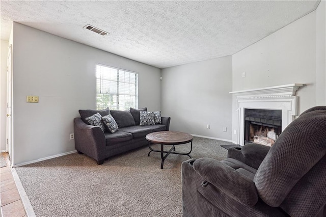 living room featuring light carpet and a textured ceiling