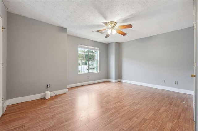 unfurnished room featuring light hardwood / wood-style flooring, a textured ceiling, and ceiling fan