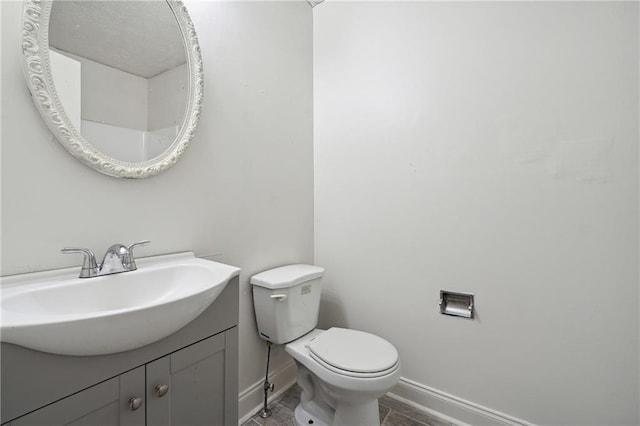 bathroom featuring toilet and vanity