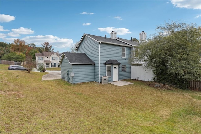 rear view of property with a yard