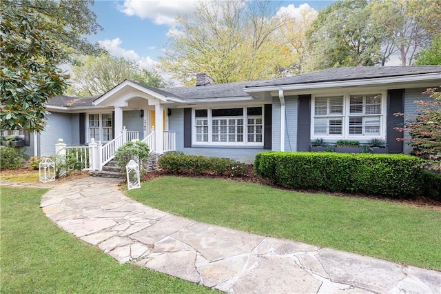 ranch-style house with covered porch and a front yard