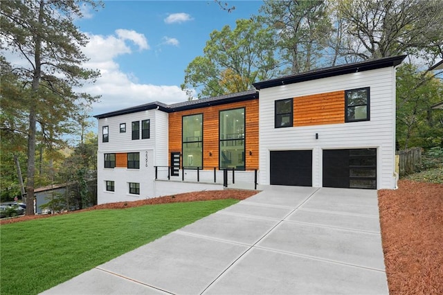 modern home featuring a garage and a front lawn