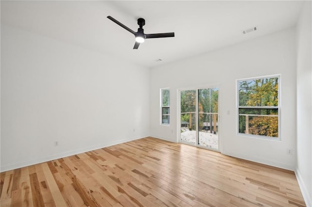 empty room with light hardwood / wood-style flooring and ceiling fan