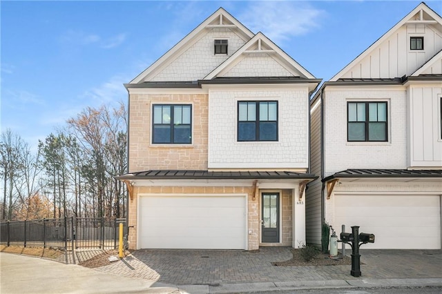 property entrance featuring decorative driveway and an attached garage