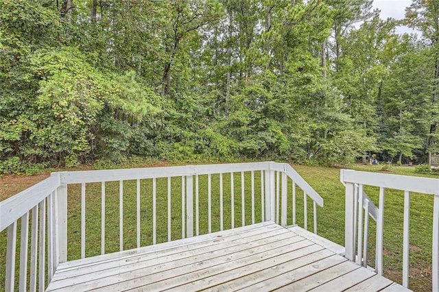 wooden terrace with a lawn