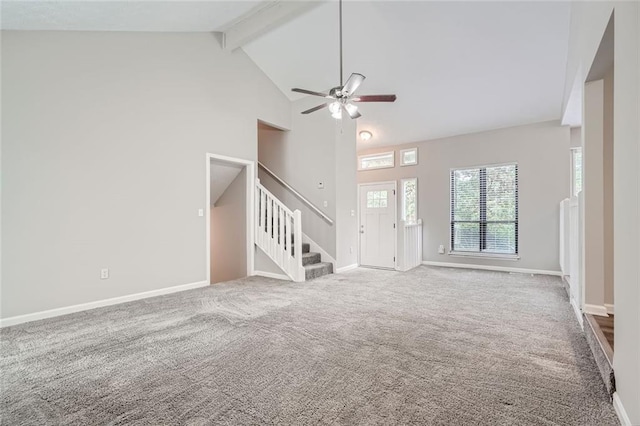 unfurnished living room featuring ceiling fan, beam ceiling, carpet flooring, and high vaulted ceiling