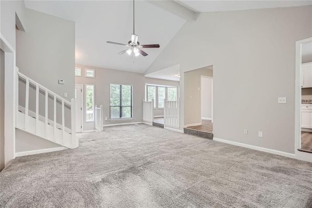 unfurnished living room with high vaulted ceiling, carpet, ceiling fan, and beamed ceiling