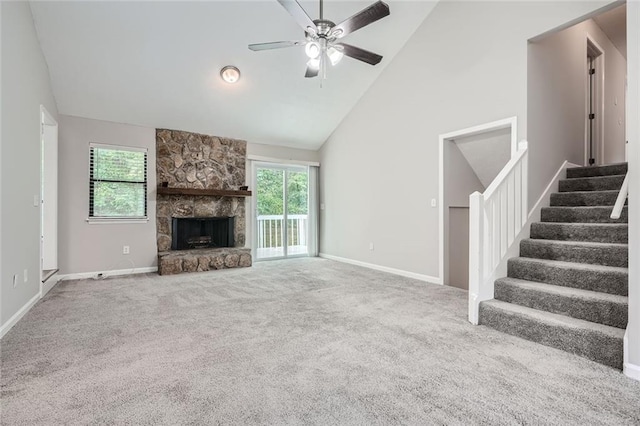 unfurnished living room featuring high vaulted ceiling, ceiling fan, carpet floors, and a fireplace