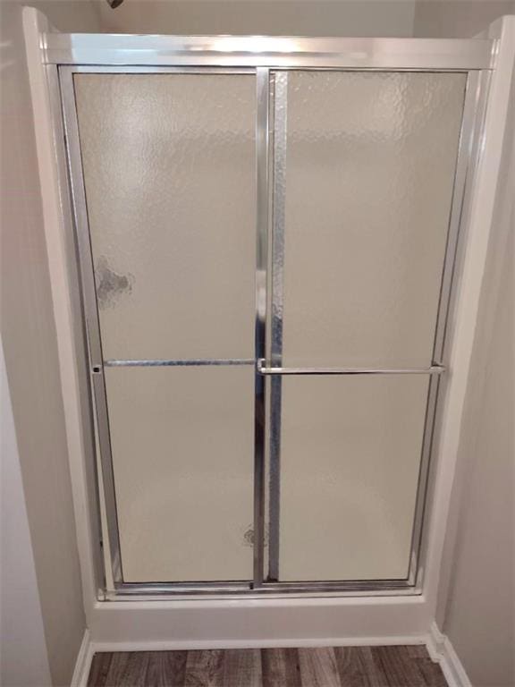 bathroom featuring walk in shower and hardwood / wood-style floors