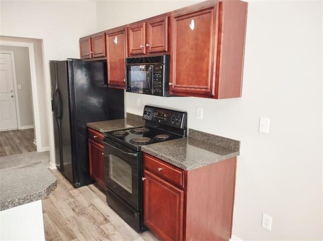 kitchen featuring light hardwood / wood-style flooring and black appliances