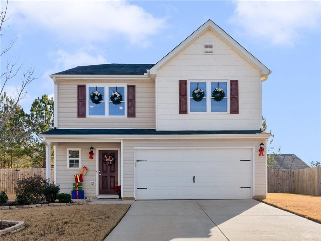 view of property featuring a front lawn and a garage