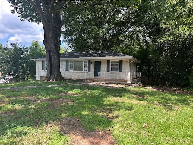 3129 Nursery Rd, Smyrna, GA 30082 - view of front of home with brick siding, a front yard, and a porch