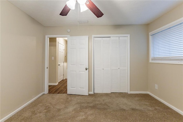 unfurnished bedroom with carpet flooring, ceiling fan, and a closet