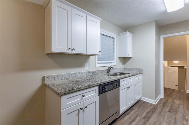 kitchen featuring light stone counters, stainless steel dishwasher, dark wood-type flooring, sink, and white cabinets